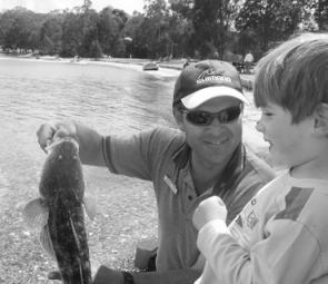 Ben Cockburn, 3, with his first Lake Macquarie flathead, a 65cm beauty, which was then released.